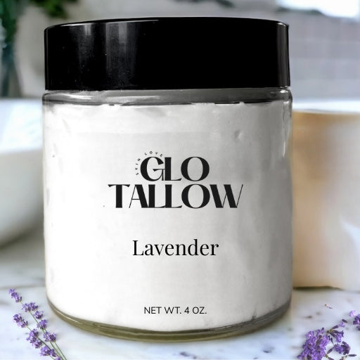 a glass jar sitting on a bathroom counter with a black lid and filled with Lavender Tallow 